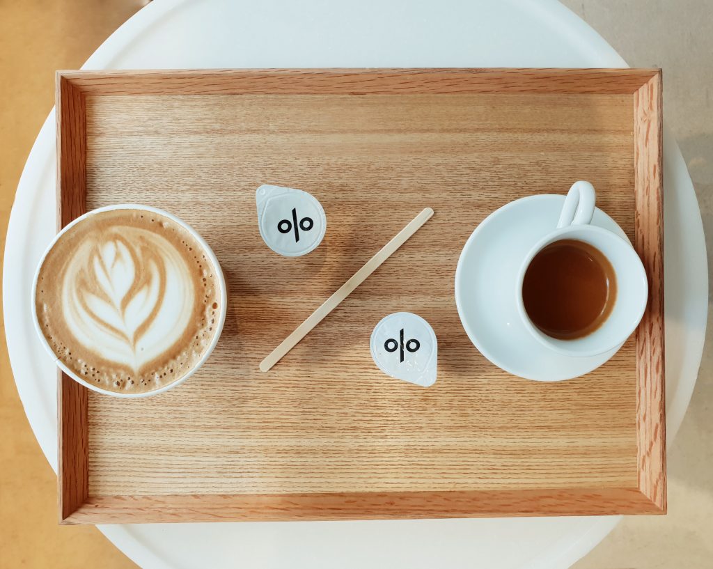 Coffee showing a percentage sign % with stirrer and milk pots